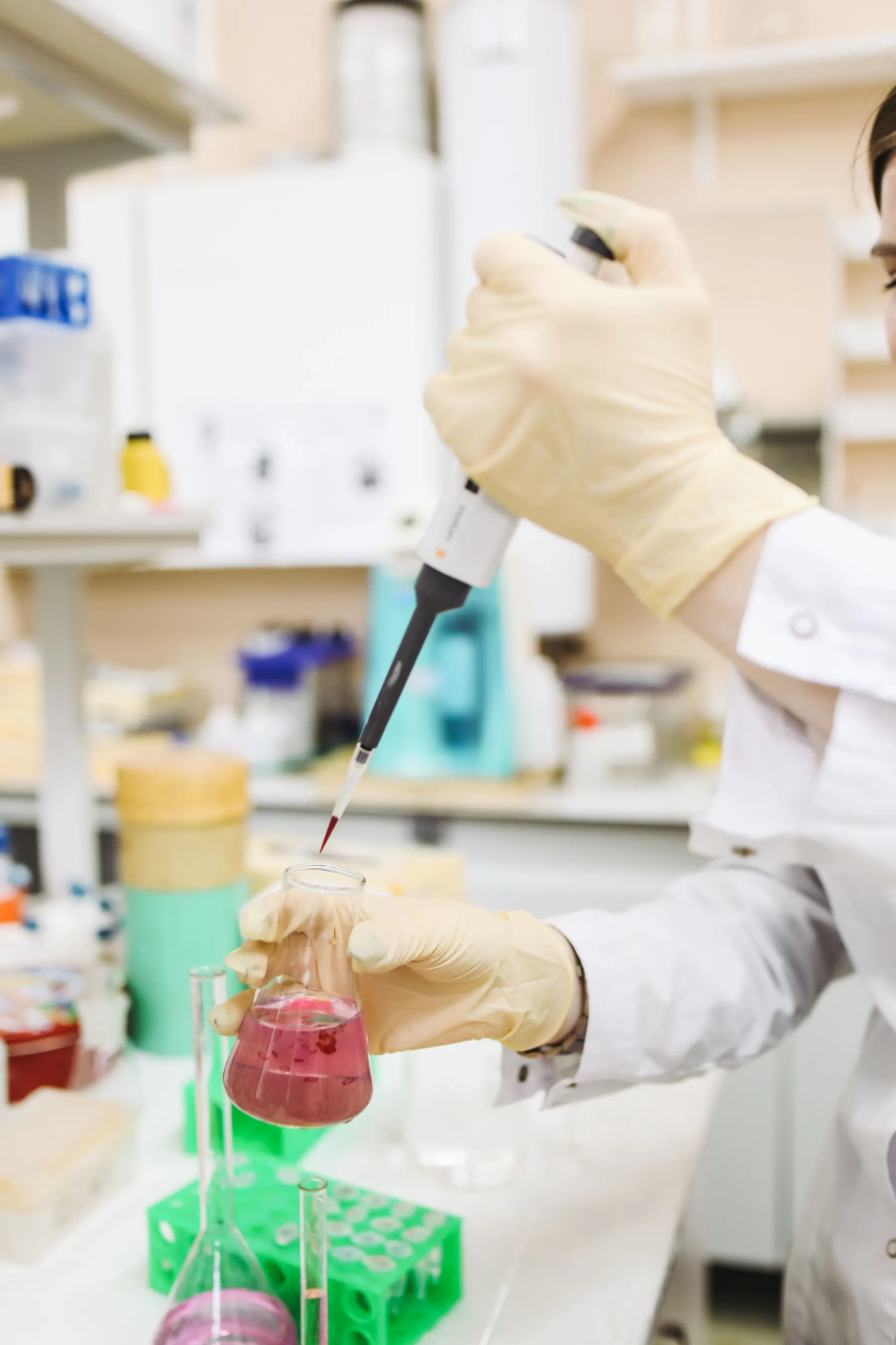 Laboratory technician transferring a measured liquid sample